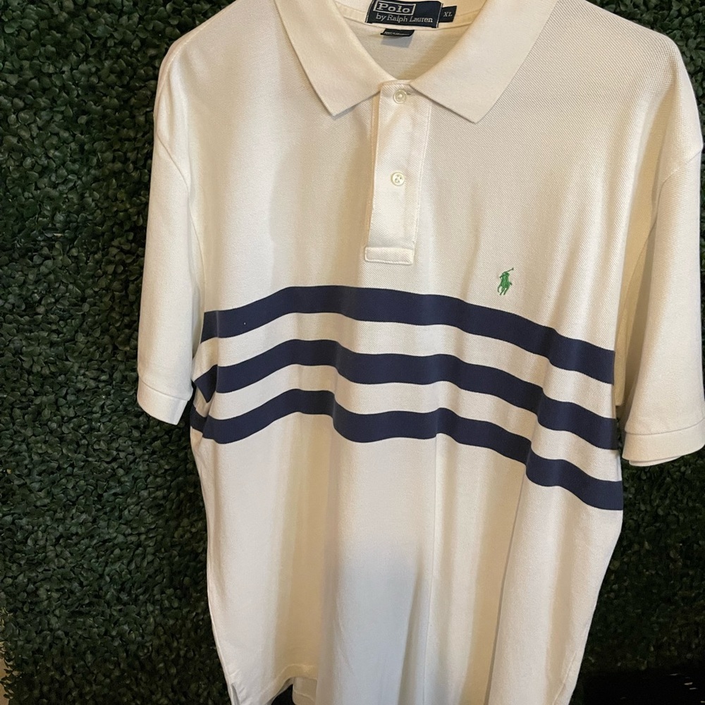 White polo by Ralph Lauren shirt with two buttons with green logo.